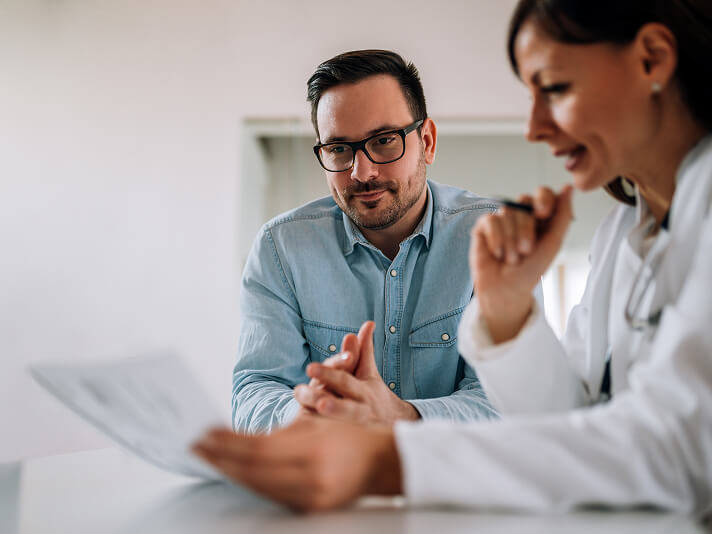 man talking to medical professional