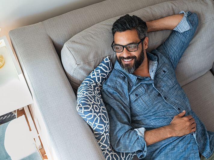 man smiling on couch